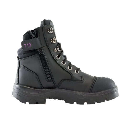 A black Steel Blue ladies safety boot with a scalloped collar, padded tongue, and side zipper. It features a lace-up front and a steel toe cap.