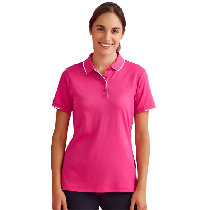 Woman wearing a pink polo shirt on a white background
