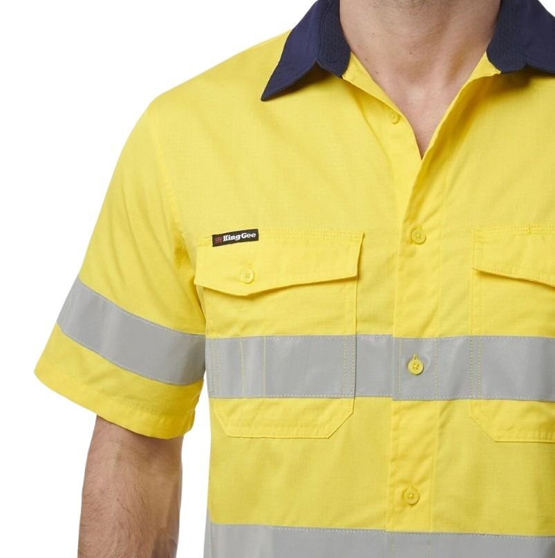 Yellow work shirt with reflective strip and brand logo on a white background