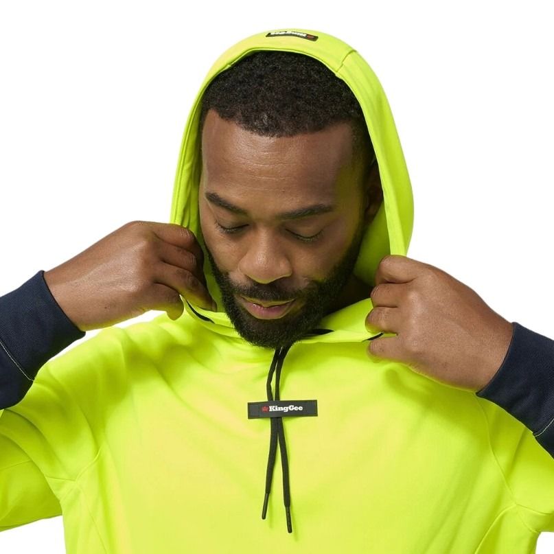 Person wearing a bright yellow hoodie with a brand logo on a white background