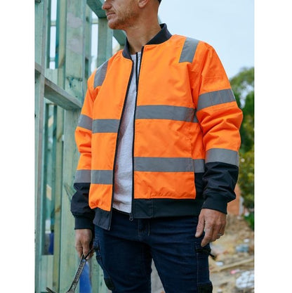 Person wearing an orange high-visibility jacket with reflective stripes outdoors.