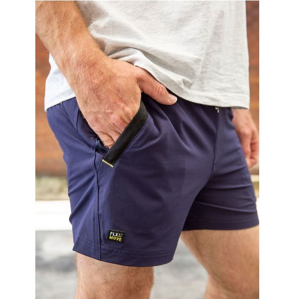 Person wearing navy shorts with a visible brand logo, holding a black object.