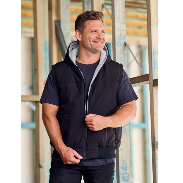Man wearing a black vest with a blurred background