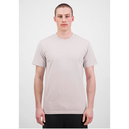 Man wearing a plain beige t-shirt on a white background