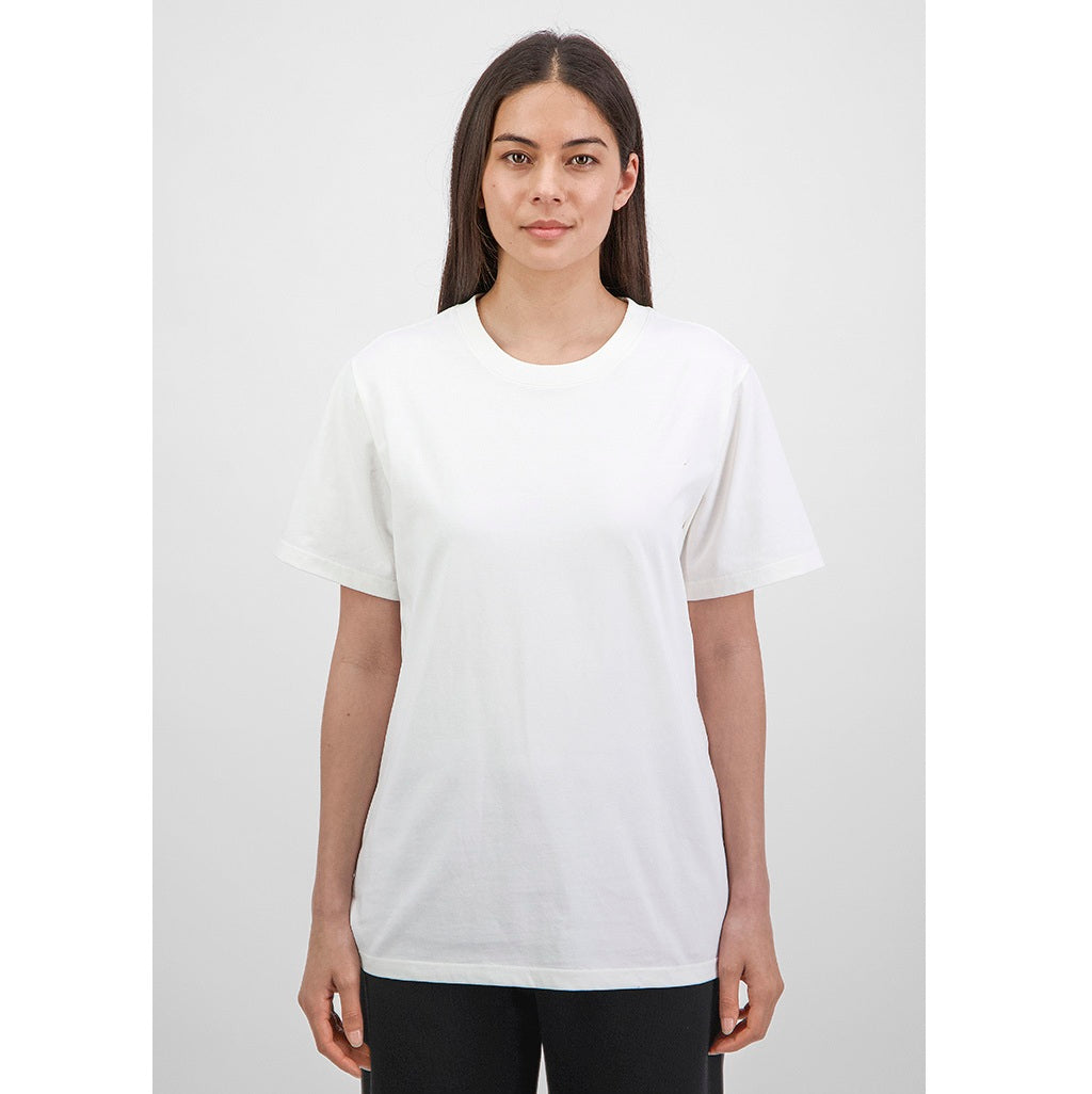Woman wearing a white t-shirt against a plain background