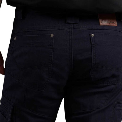 Close-up of dark blue pants with a brand label on a white background