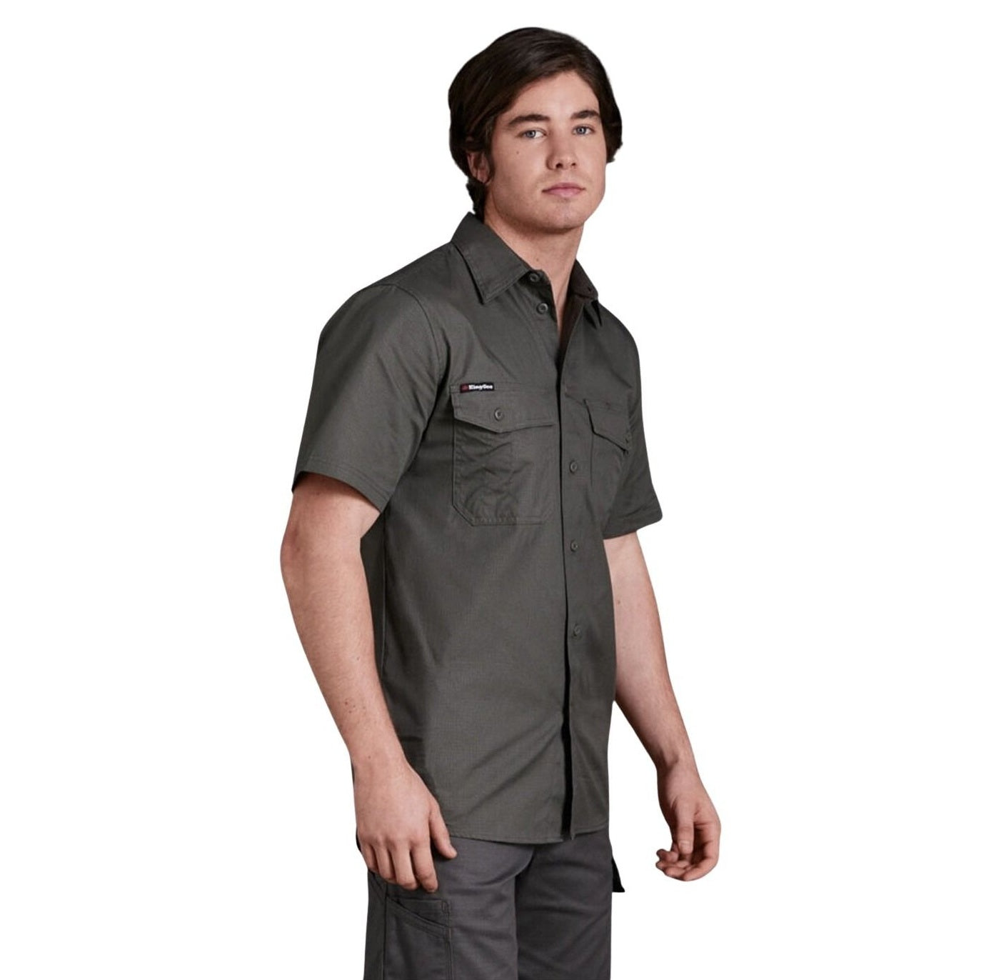 Man wearing a dark gray short-sleeve shirt on a white background