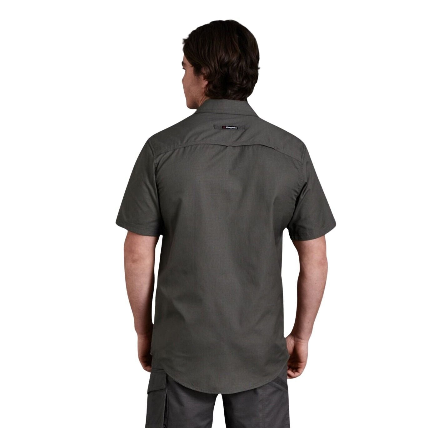 Person wearing a dark gray short-sleeve shirt on a white background