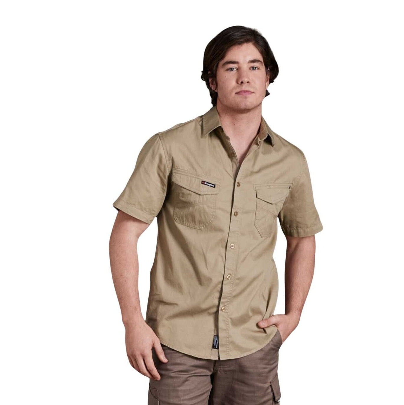 Man wearing a beige short-sleeve shirt on a white background