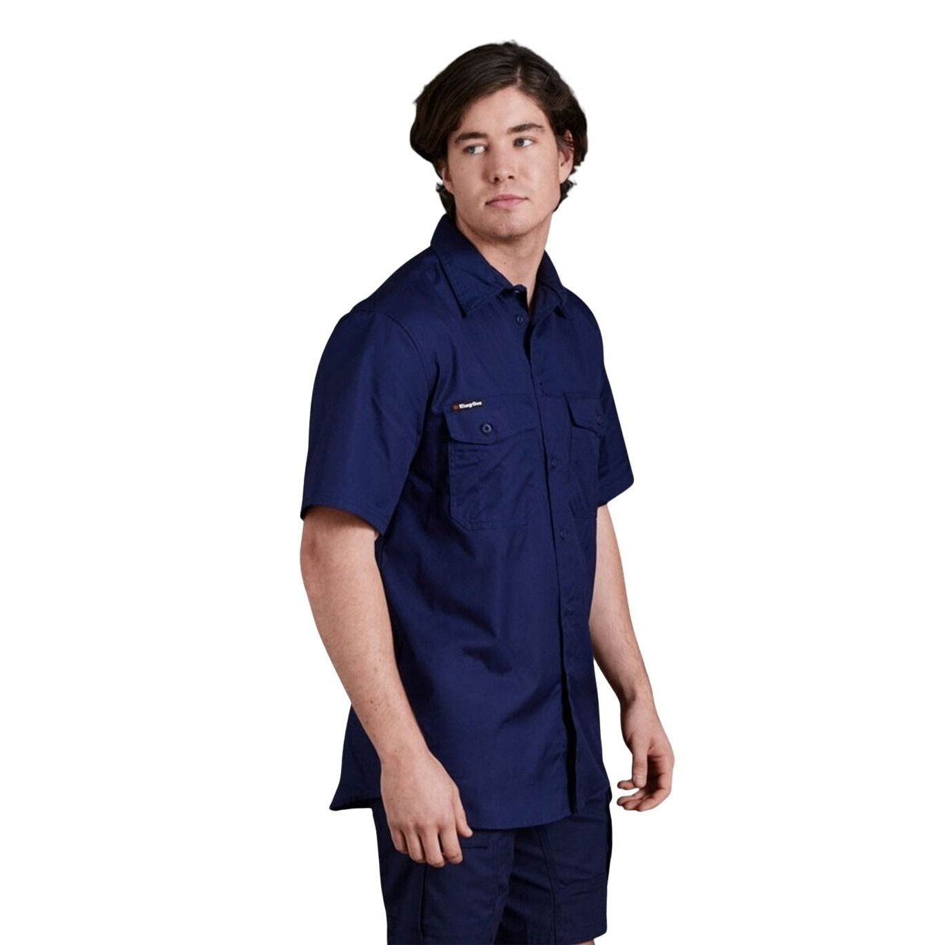 Person wearing a navy blue work shirt on a white background