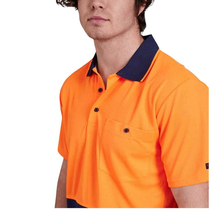 man wearing orange and navy polo on white background