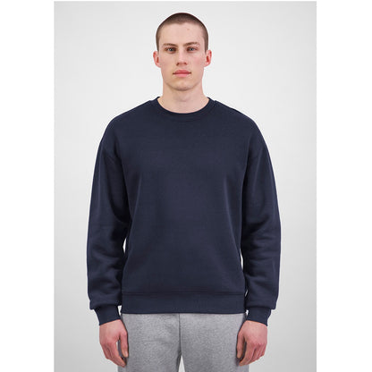 Person wearing a navy blue sweatshirt and gray pants on a white background