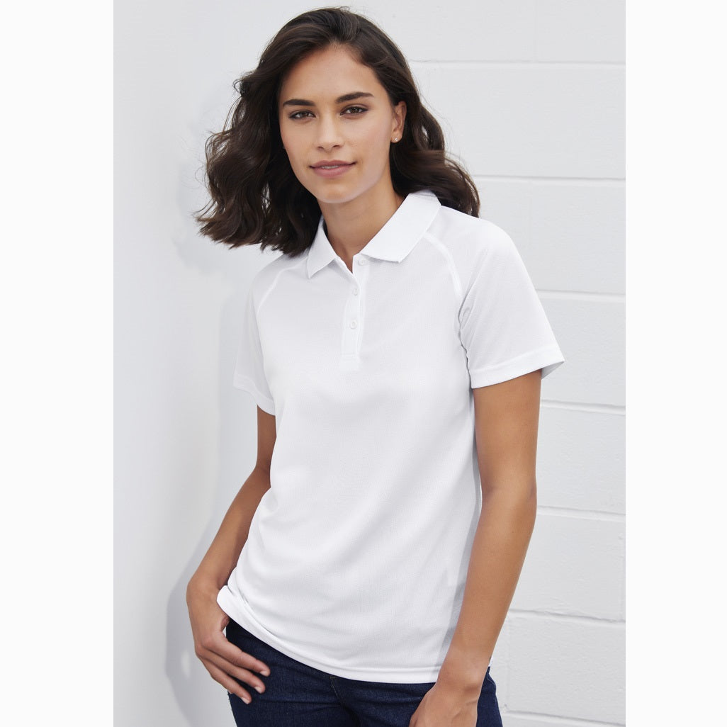 A woman wearing a white Biz Collection ladies' polo shirt with a collar, short sleeves, and a slim fit.