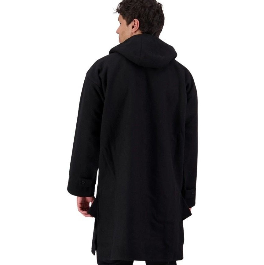 Person wearing a black coat on a white background