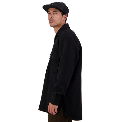 Man wearing a black coat and cap on a white background