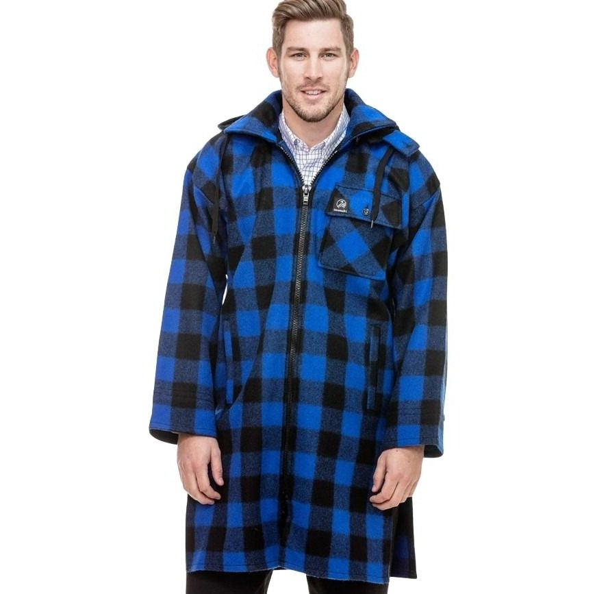 Man wearing a blue and black checkered coat on a white background