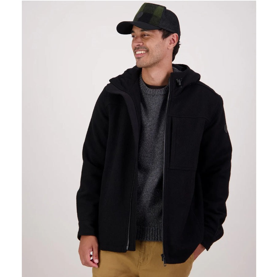 Man wearing a black jacket, gray sweater, and green cap on a white background