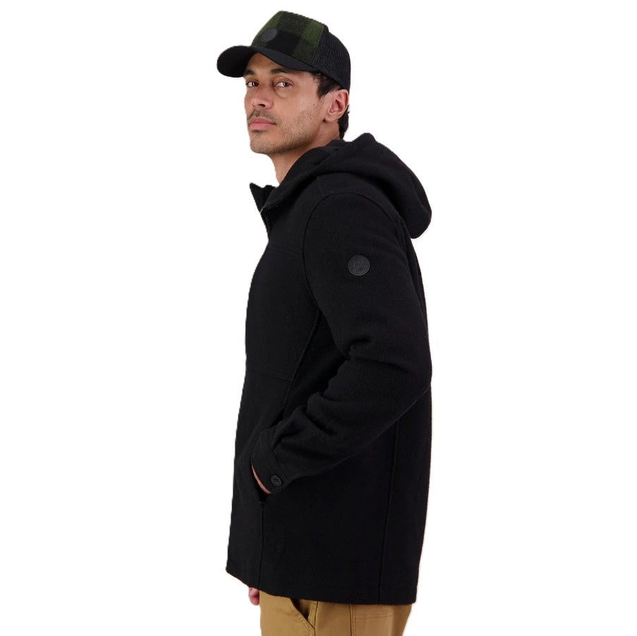 Man wearing a black jacket and cap on a white background