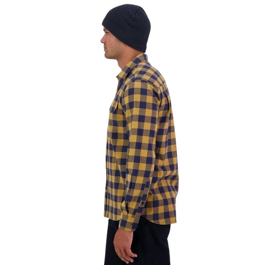 Person wearing a yellow and blue plaid shirt with a beanie on a white background