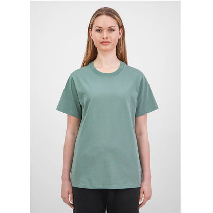 Woman wearing a green t-shirt against a white background