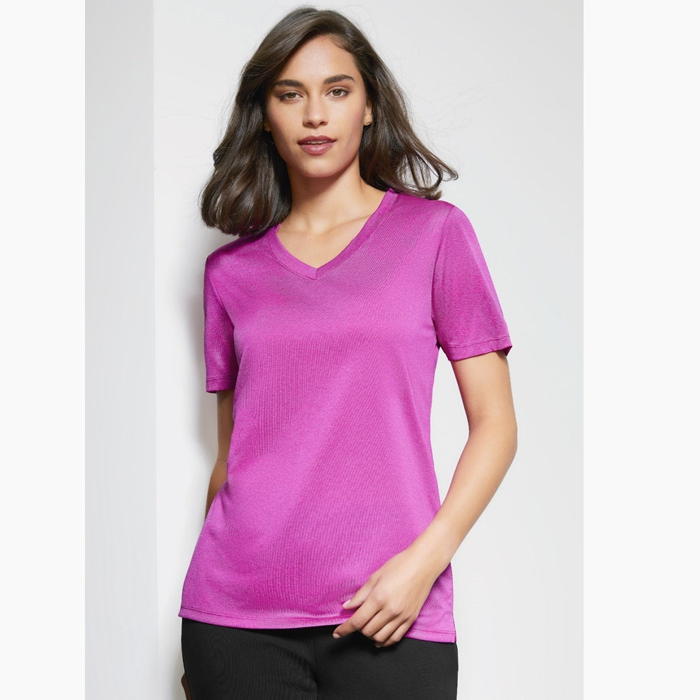 A woman wearing a pink purple Biz Collection V-neck t-shirt.
