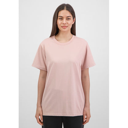 Woman wearing a light pink t-shirt against a white background