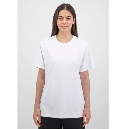 Woman wearing a plain white t-shirt against a light gray background