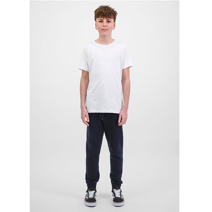 Person wearing a white t-shirt and dark pants on a plain background