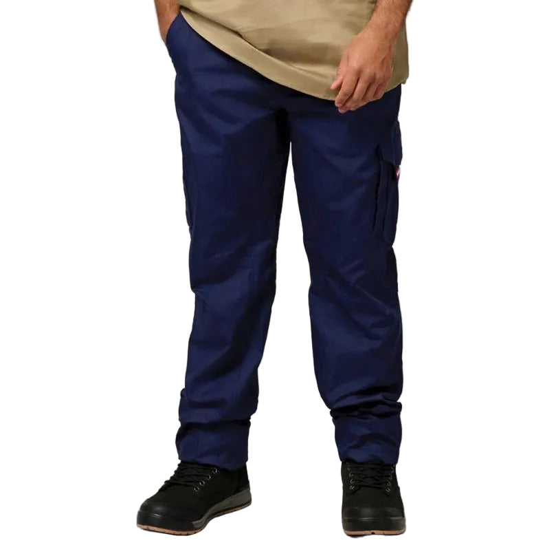 A person standing against a white background, wearing navy blue cargo pants with multiple pockets and black shoes.