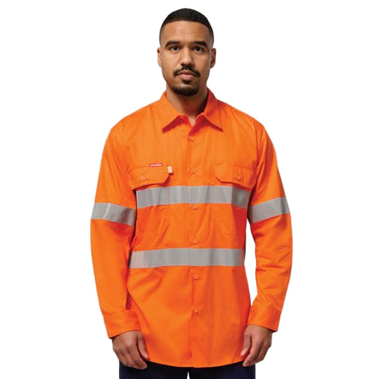A person wearing an orange high-visibility cotton twill shirt with reflective silver stripes and button down chest pockets.