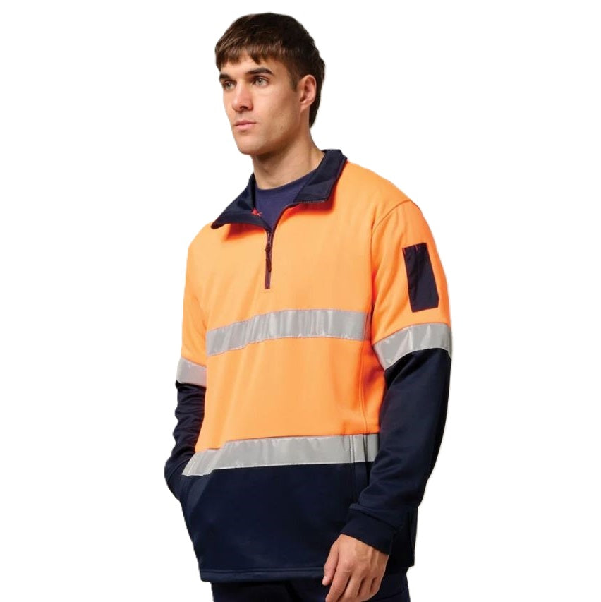 Person wearing an orange and navy high-visibility work shirt on a white background