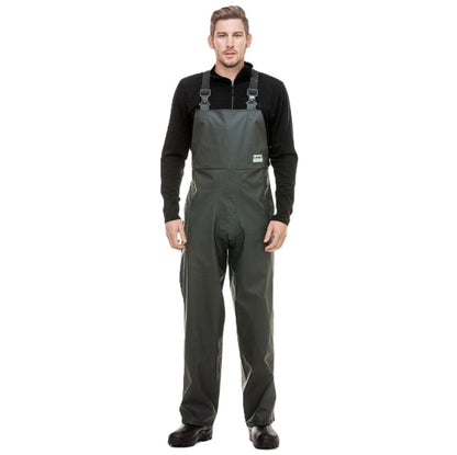 Man wearing a black long-sleeve shirt and gray bib overalls on a white background