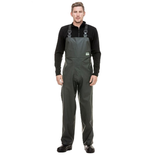 Man wearing a black long-sleeve shirt and gray bib overalls on a white background