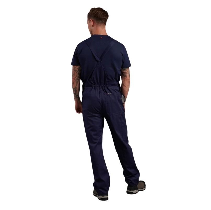 Person wearing a navy blue jumpsuit on a white background