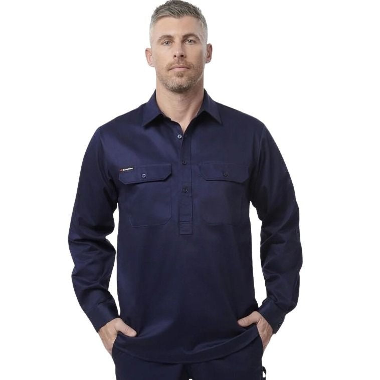 Man wearing a navy long-sleeve shirt on a white background