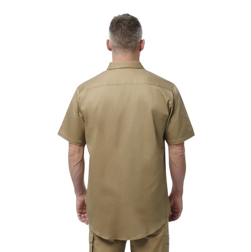Man wearing a beige short-sleeve shirt on a white background