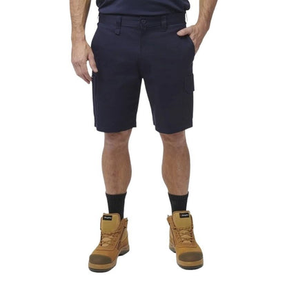 Person wearing navy cargo shorts and brown work boots on a white background