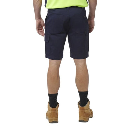 Person wearing navy shorts, black socks, and brown boots on a white background