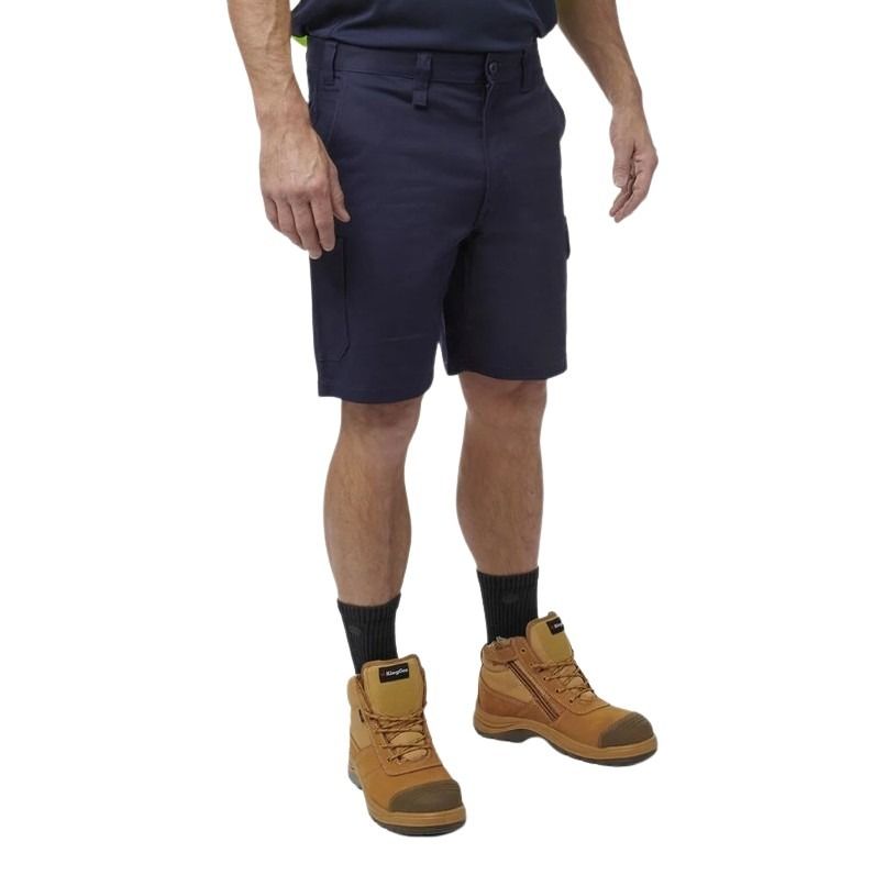 Person wearing navy shorts and brown boots on a white background