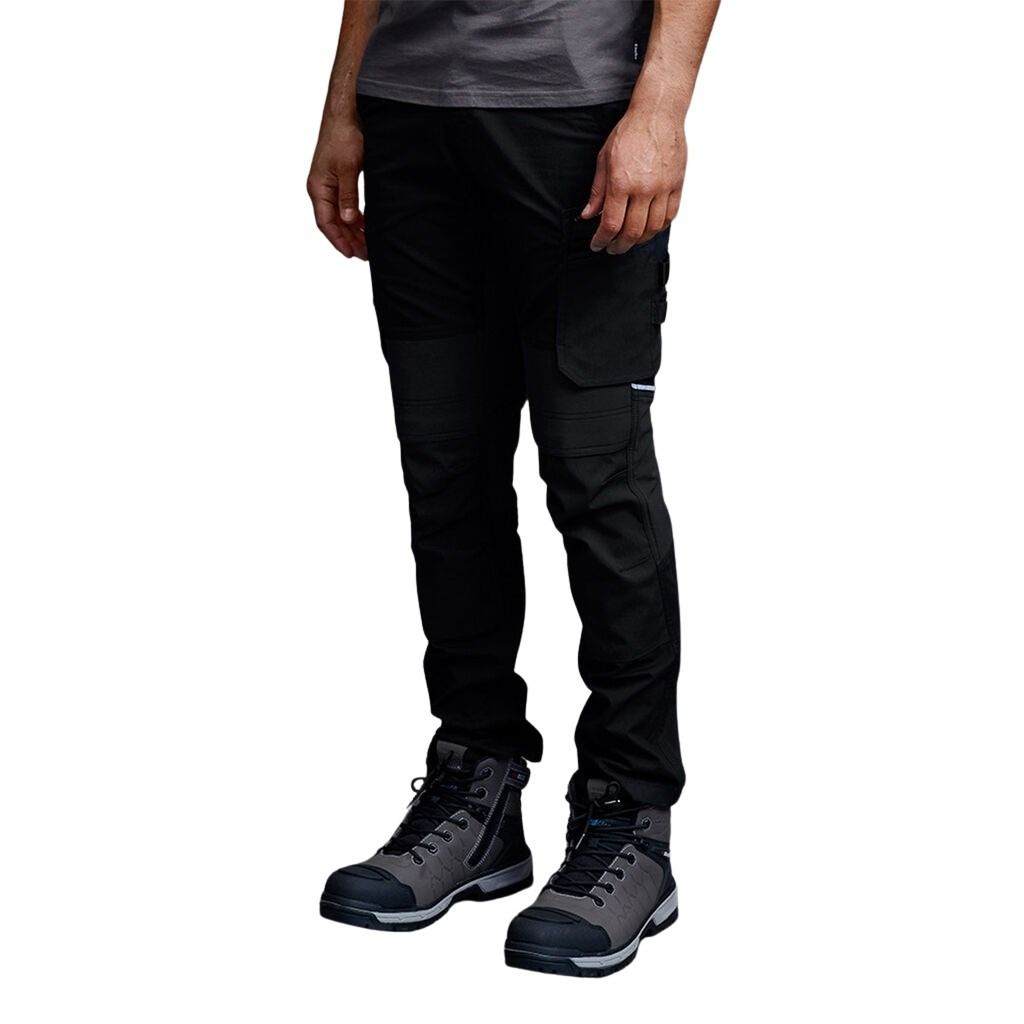Person wearing black pants and hiking boots on a white background