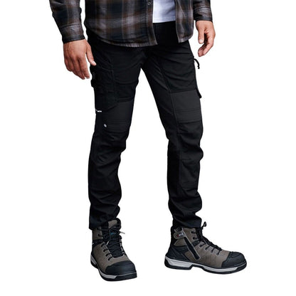 Person wearing black pants and gray hiking boots on a white background