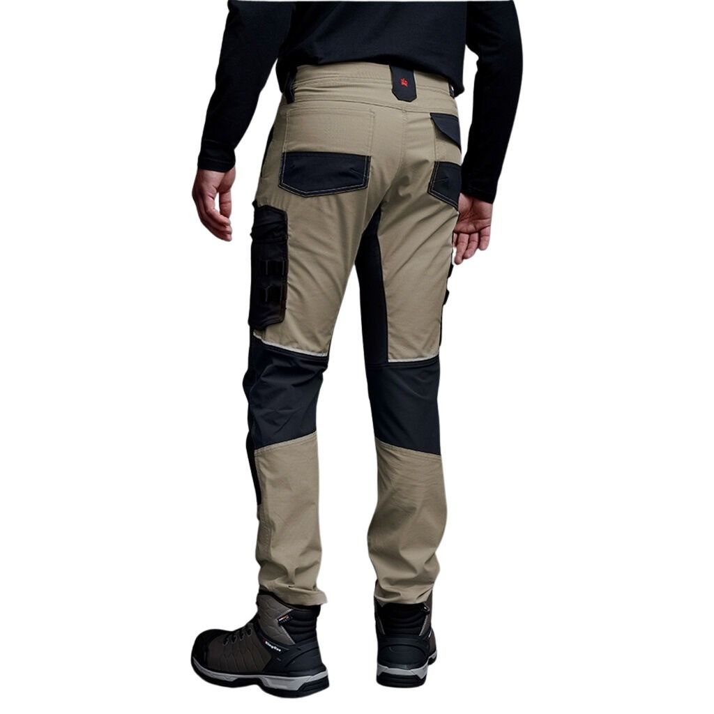 Beige and black pants worn by a person on a white background