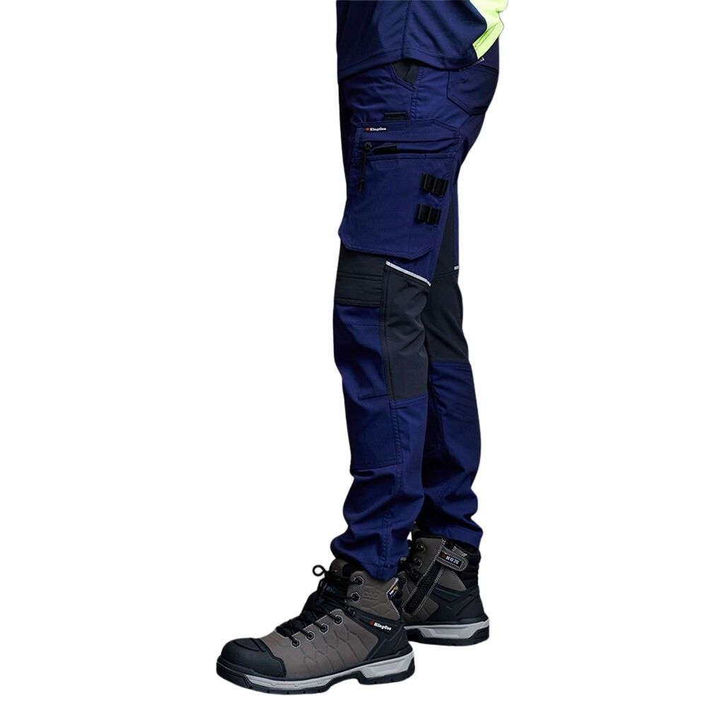 Navy and black work pants with hiking boots on a white background