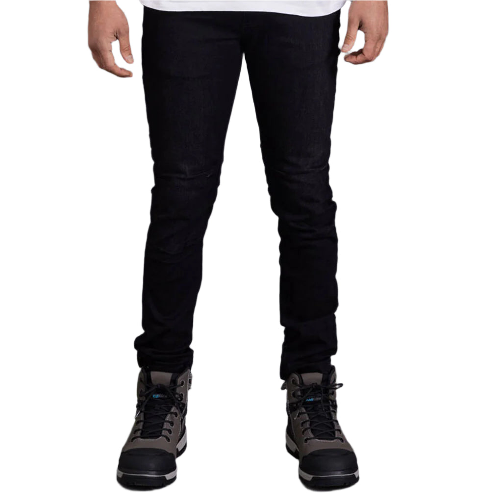 Person wearing black jeans and gray boots on a gray background