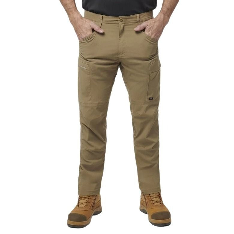 Person wearing tan work pants with pockets on a white background