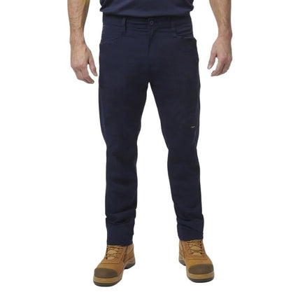 Person wearing navy pants and brown boots on a white background