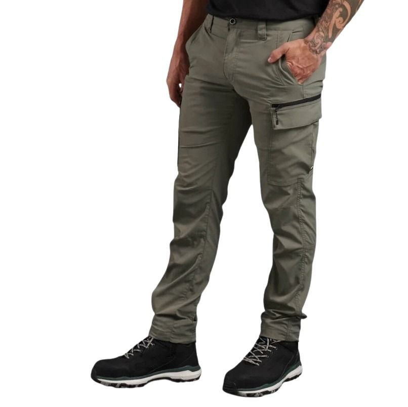 Person wearing beige pants with zippers on a white background