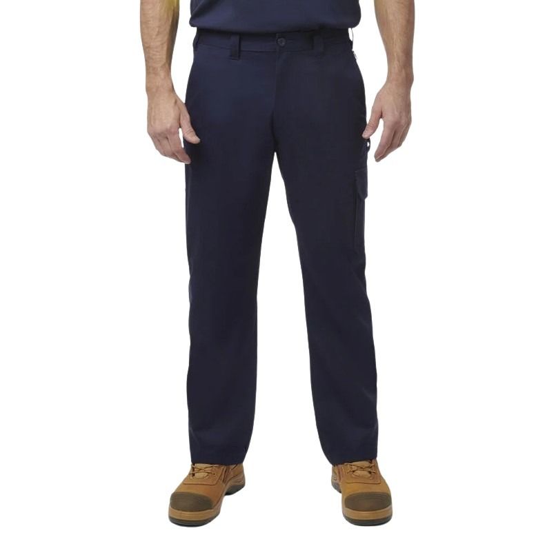 Person wearing navy pants and brown boots on a white background