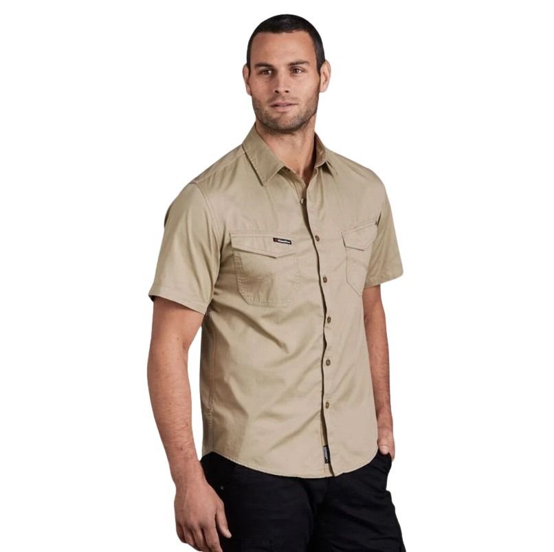 Man wearing a beige short-sleeve shirt on a white background