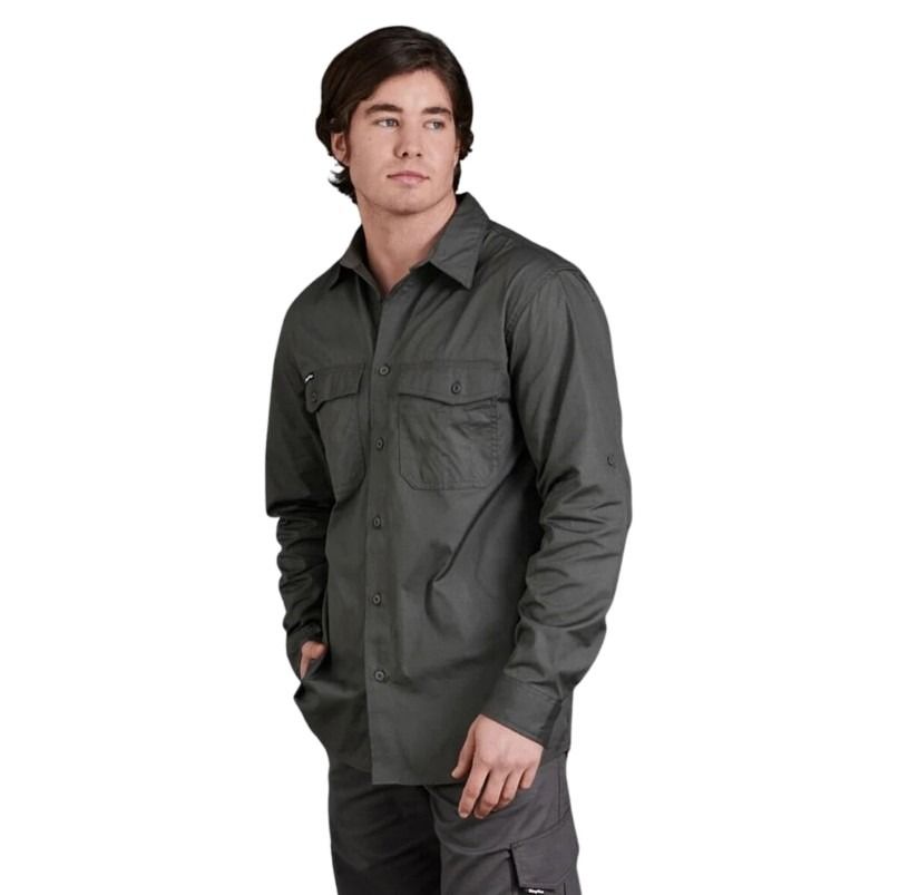 Person wearing a dark green shirt with two front pockets on a white background